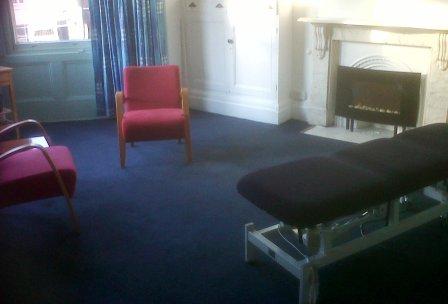 massage therapy room at quaker meeting house - luxurious room with fire place and bay windows